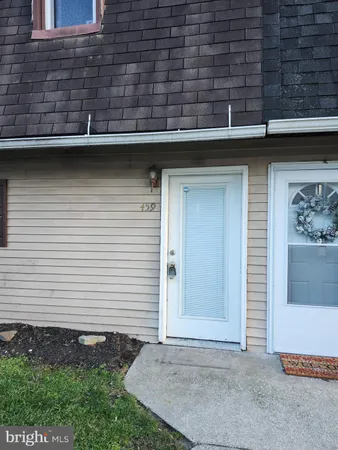 a view of a house with a door and a yard
