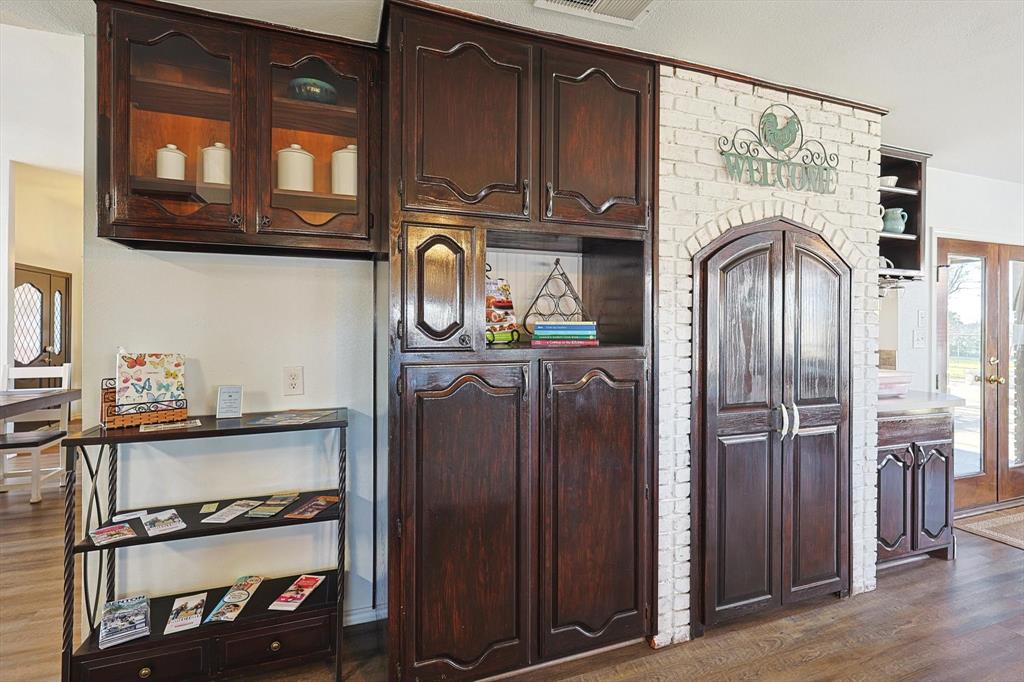 7185 Mesquite Ridge Sanger, TX 76266 - Photo 15 of 40 Kitchen featuring dark brown cabinets and dark wood-type flooring