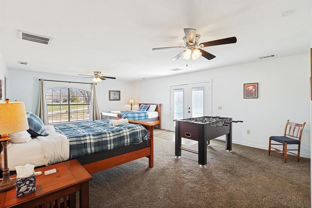 7185 Mesquite Ridge Sanger, TX 76266 - Photo 22 of 40 Bedroom featuring french doors, ceiling fan, access to exterior, and multiple windows