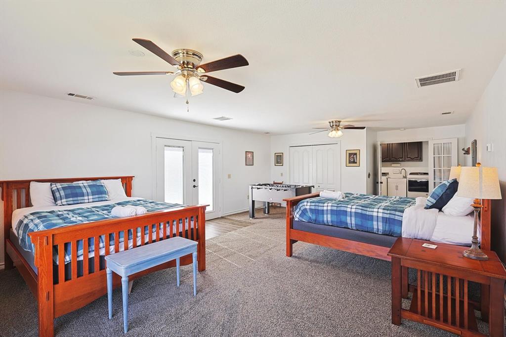 7185 Mesquite Ridge Sanger, TX 76266 - Photo 24 of 40 Bedroom with light carpet, french doors, and ceiling fan