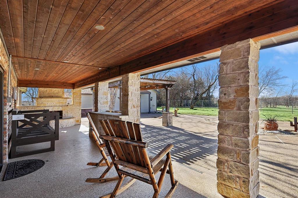 7185 Mesquite Ridge Sanger, TX 76266 - Photo 25 of 40 View of patio / terrace featuring an outdoor stone fireplace
