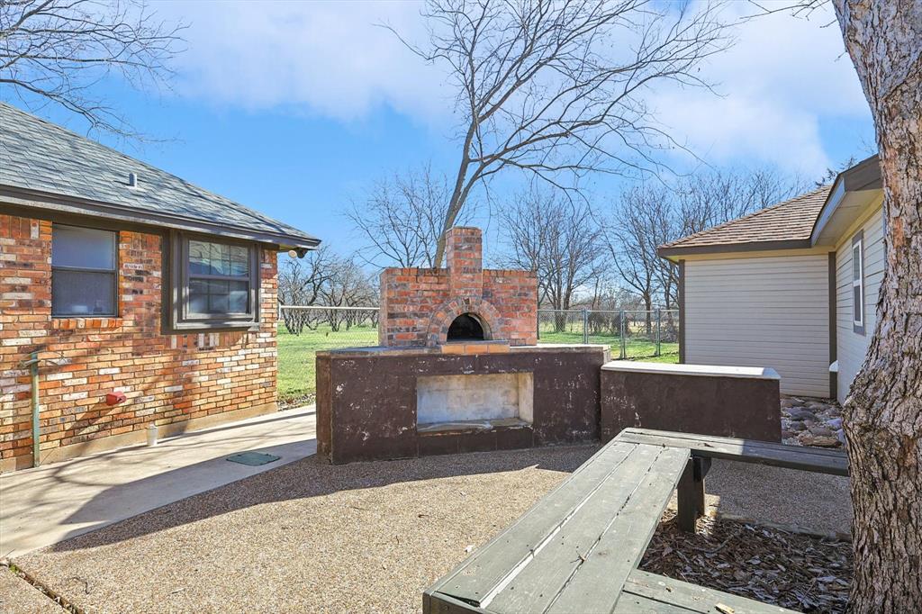 7185 Mesquite Ridge Sanger, TX 76266 - Photo 30 of 40 View of patio / terrace with a fireplace