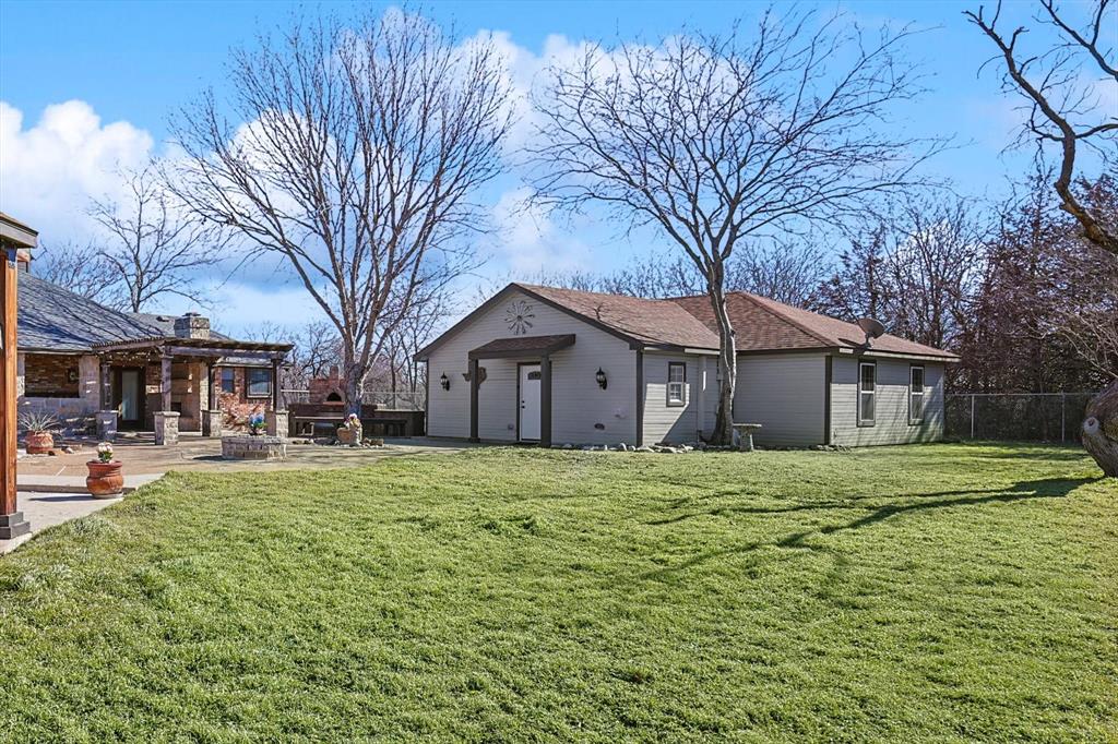 7185 Mesquite Ridge Sanger, TX 76266 - Photo 37 of 40 View of yard featuring a garage and a patio