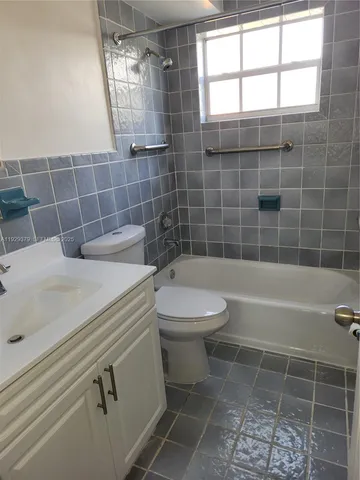 a bathroom with a toilet a sink and shower