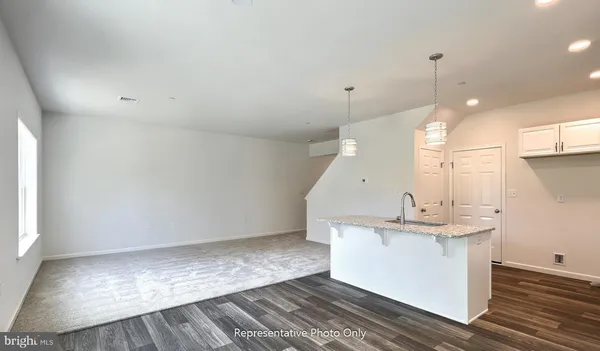 a view of a kitchen with a sink and chandelier