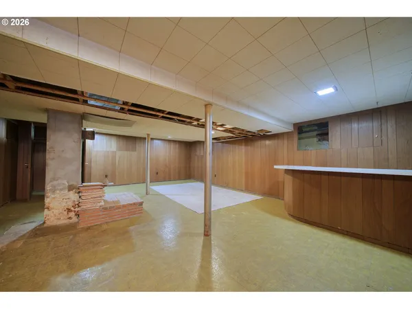 a backyard of a house with wooden floor table and chairs