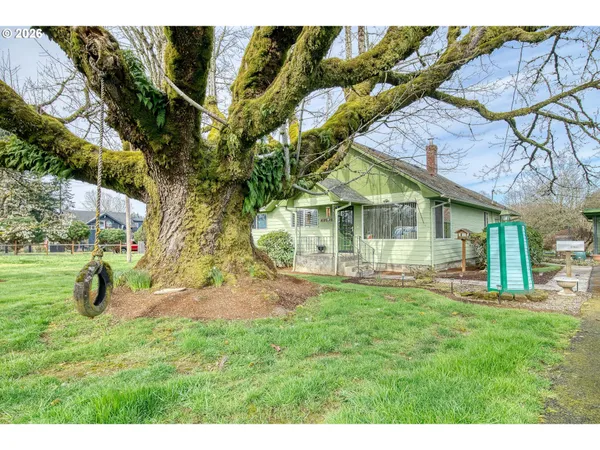 a backyard of a house with table and chairs
