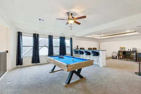 a large kitchen with stainless steel appliances kitchen island granite countertop a refrigerator a oven a sink and white cabinets