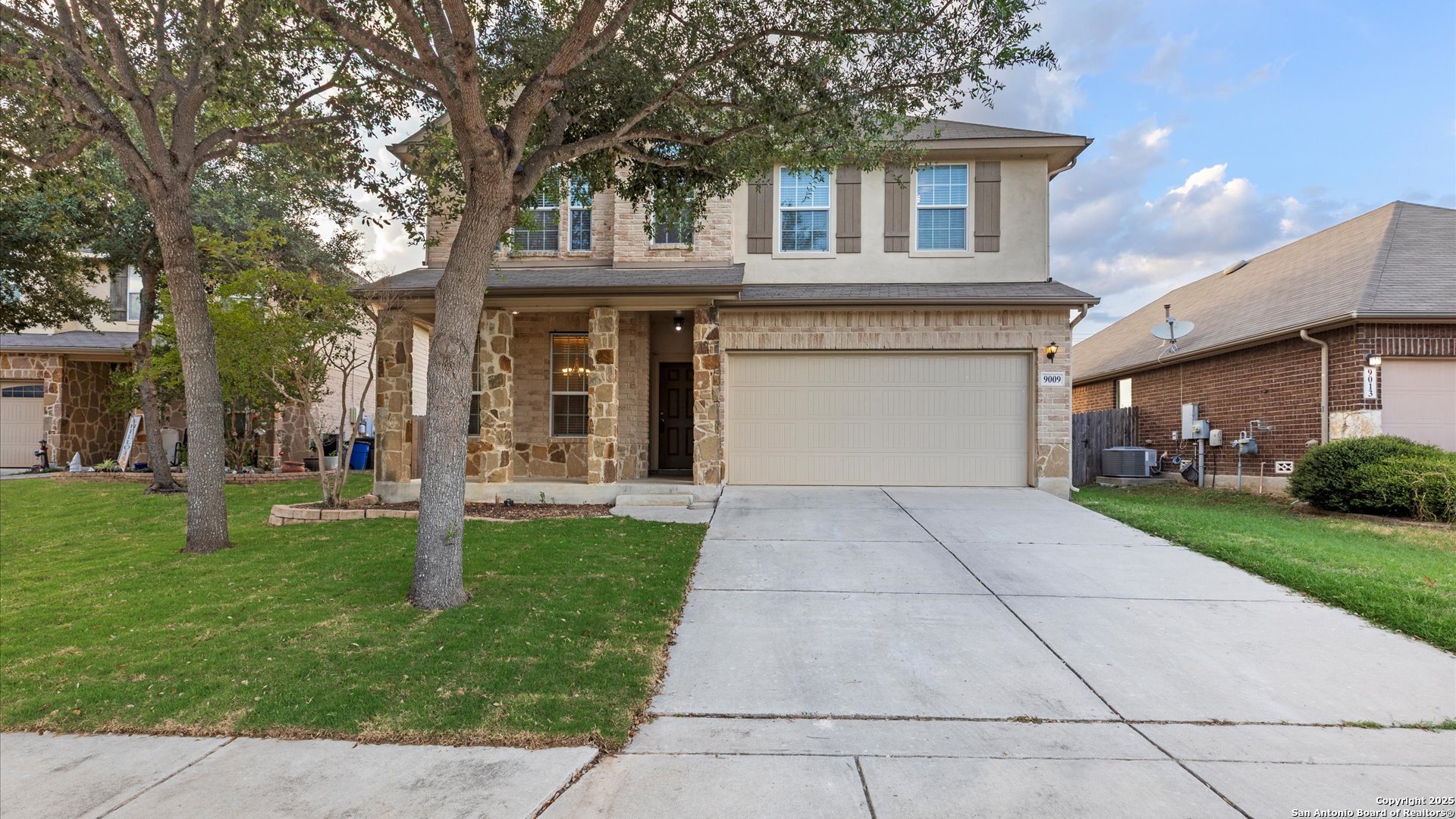 9009 Peridot Schertz, TX 78154 - Photo 1 of 28 a front view of a house with a yard