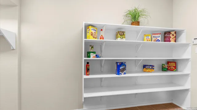 a view of a kitchen with wooden floor and a large window