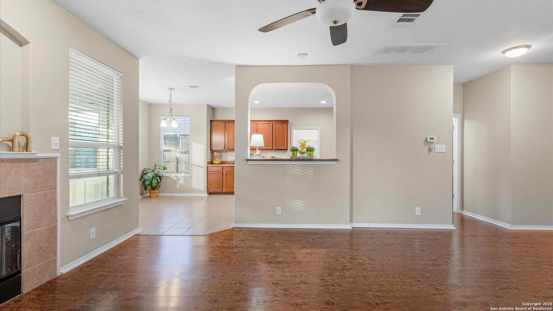 9009 Peridot Schertz, TX 78154 - Photo 13 of 28 a view of a kitchen with wooden floor and a large window