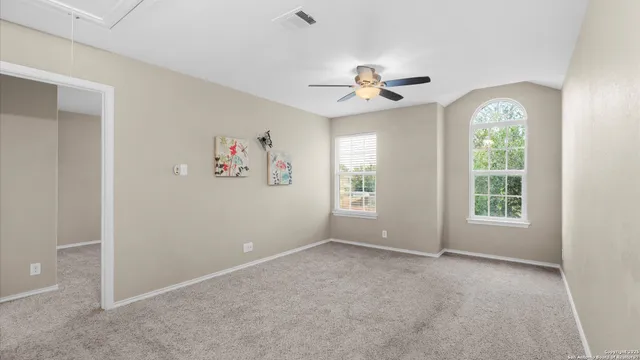 a view of livingroom with furniture ceiling fan and a window
