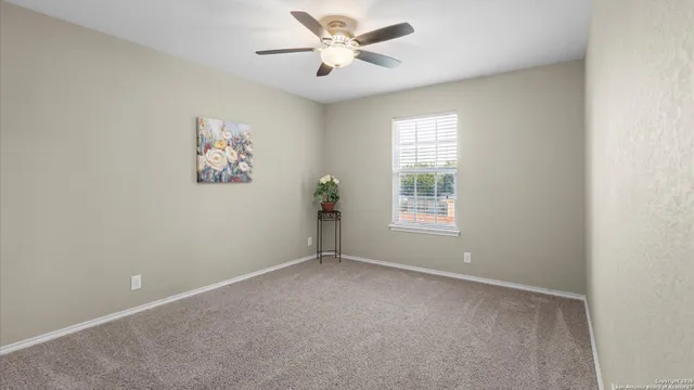 an empty room with painting on the wall