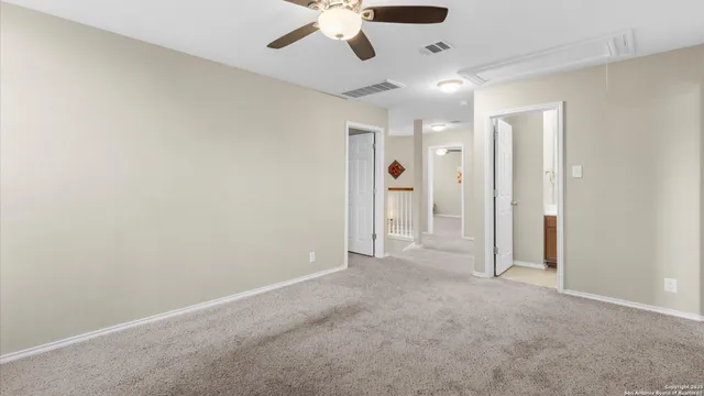 a view of an empty room and kitchen view