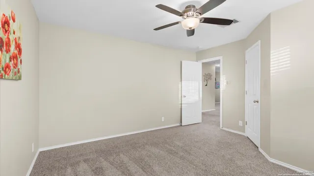 a view of a livingroom with a ceiling fan and window
