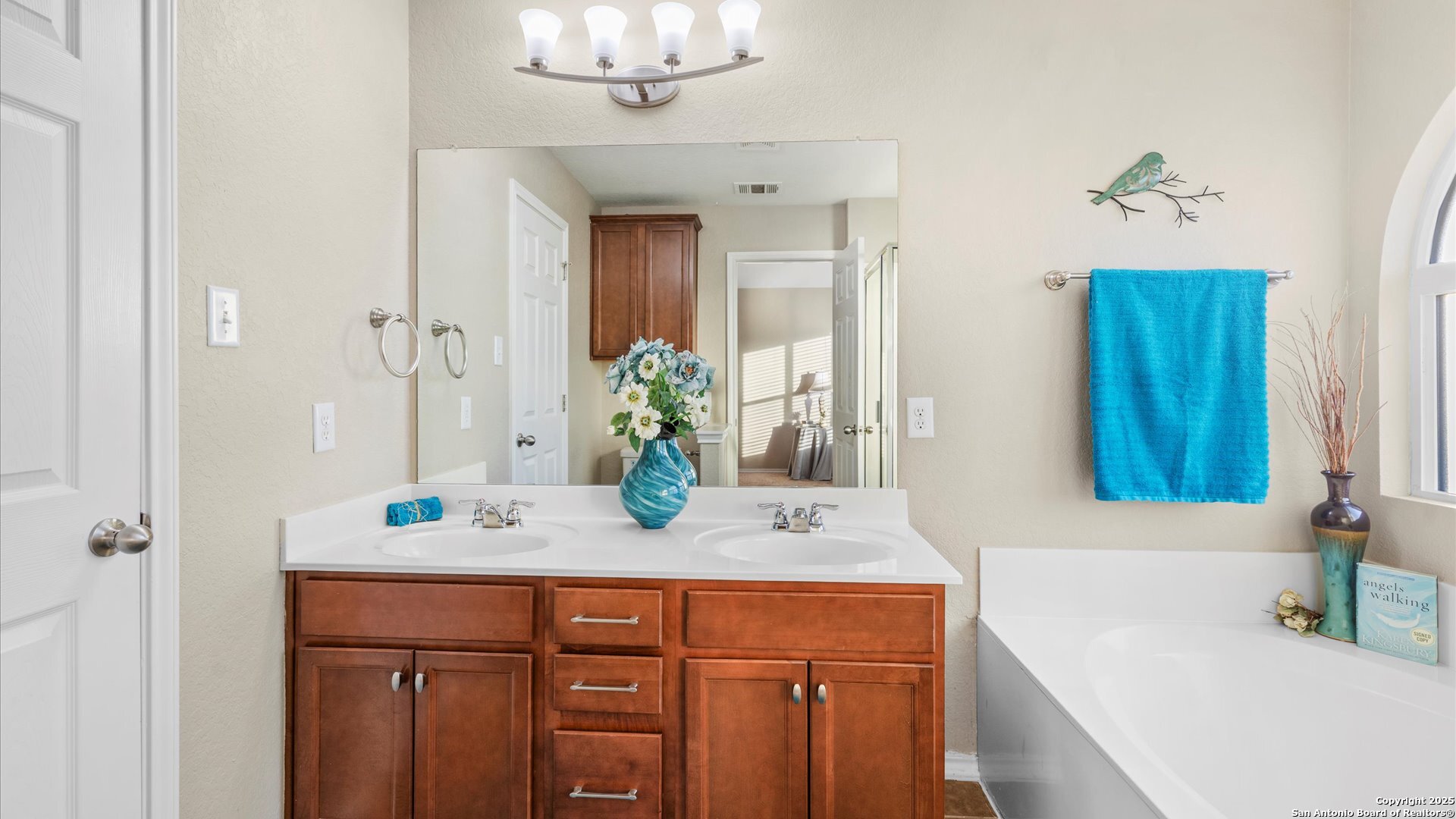 9009 Peridot Schertz, TX 78154 - Photo 24 of 28 a bathroom with a granite countertop sink a mirror and a bathtub