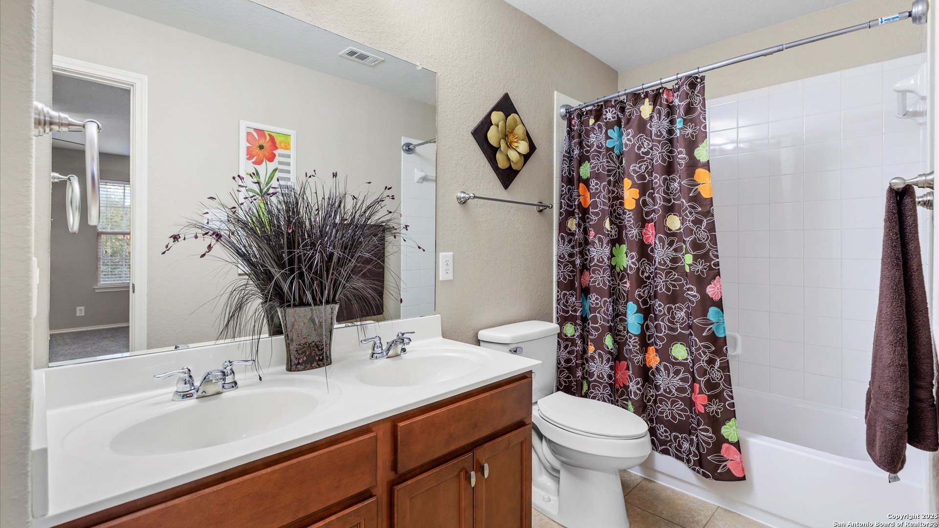 9009 Peridot Schertz, TX 78154 - Photo 26 of 28 a bathroom with a sink toilet and shower curtain