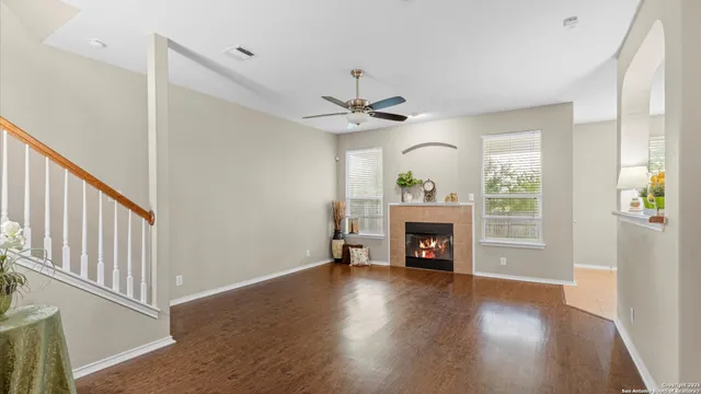 a view of an empty room with a fireplace and a window