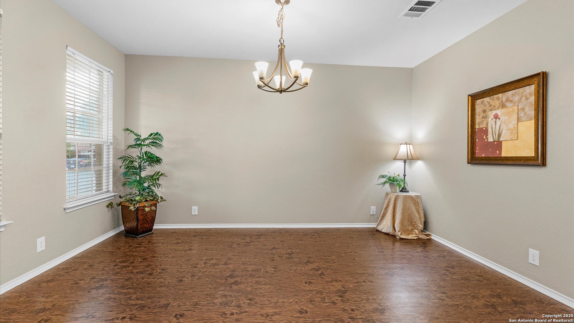 9009 Peridot Schertz, TX 78154 - Photo 7 of 28 a view of an empty room with wooden floor and a window