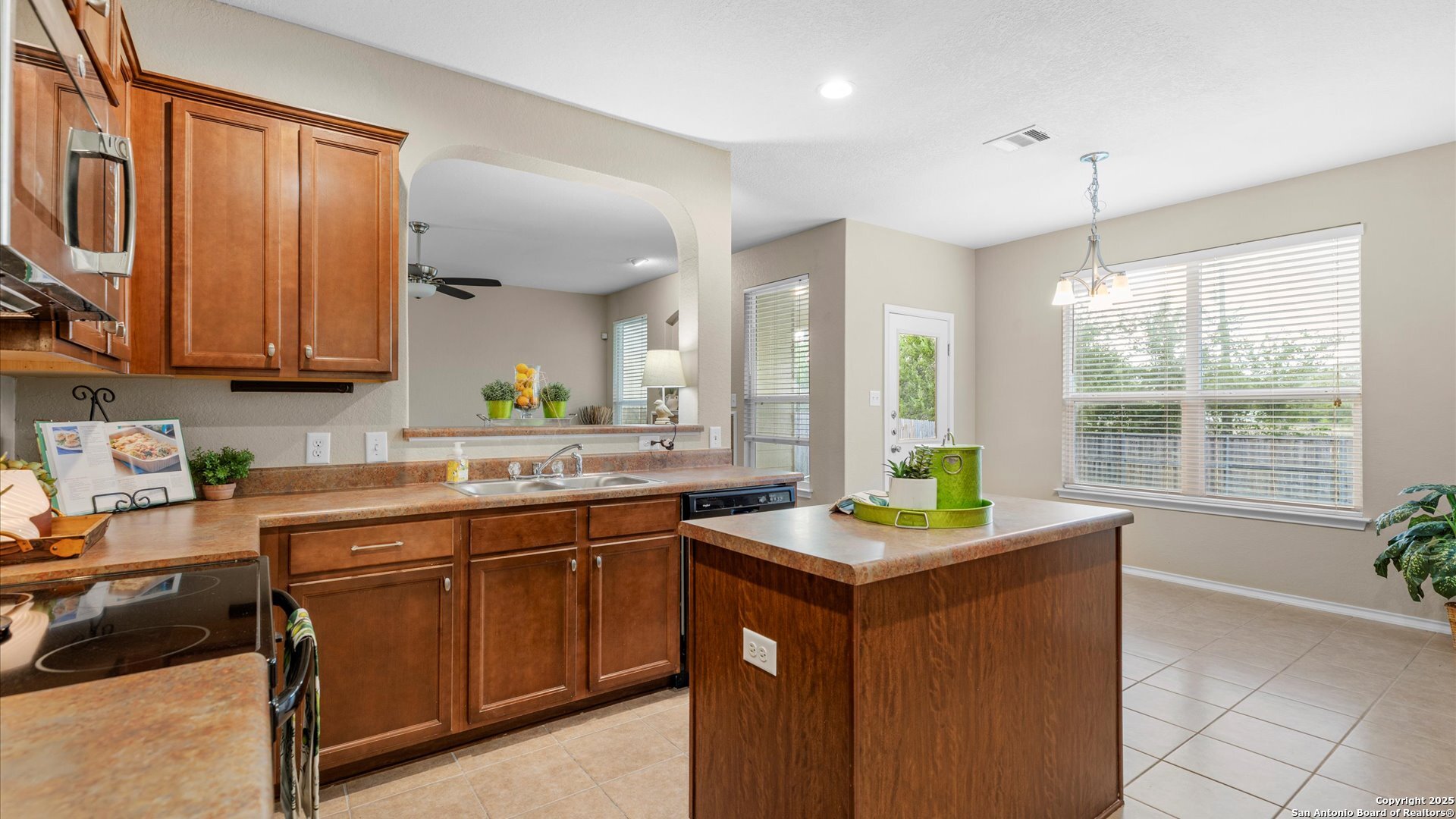 9009 Peridot Schertz, TX 78154 - Photo 10 of 28 a kitchen with a sink stove and cabinets