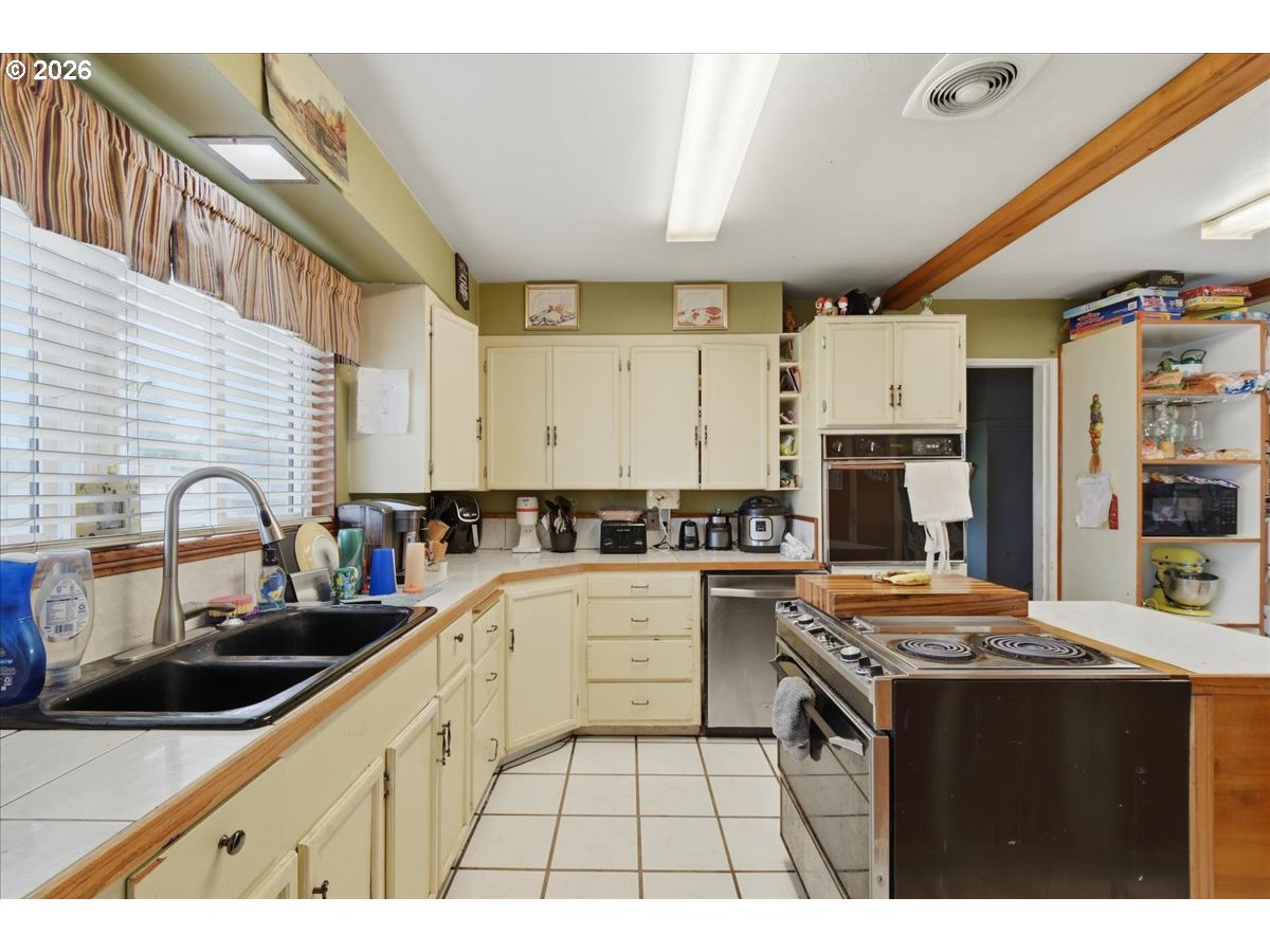 3287 Olive Way Longview, WA 98632 - Photo 7 of 24 a kitchen with a sink a stove and cabinets