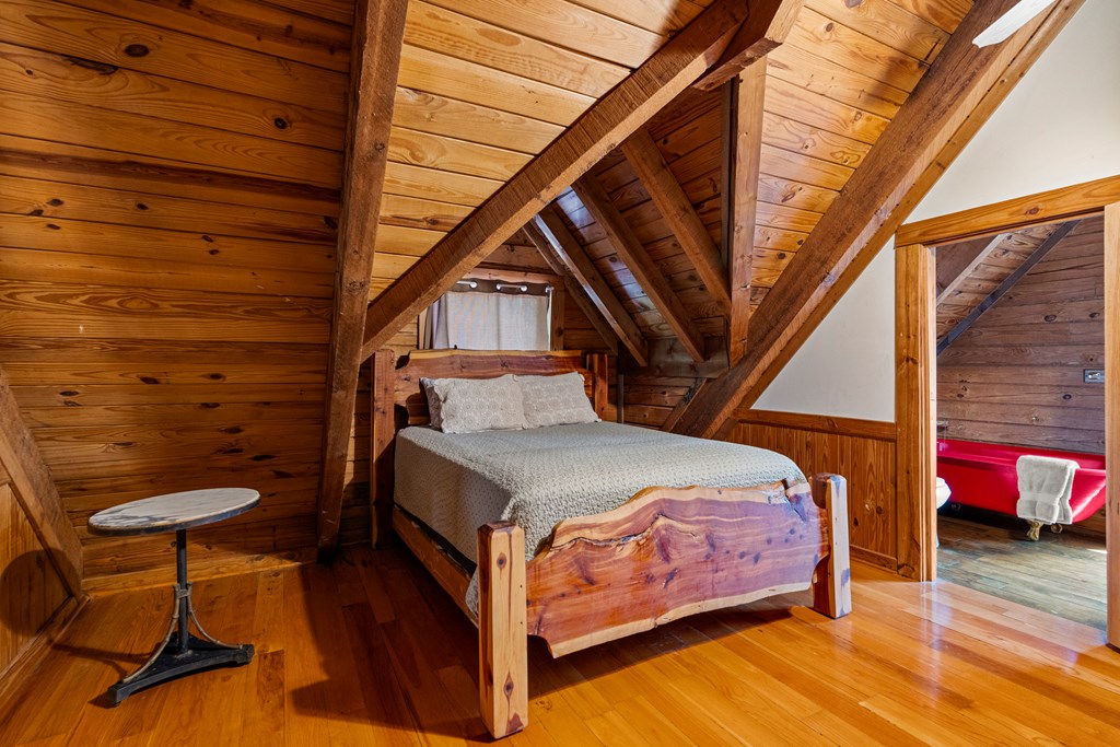 299 South L Street Hamilton, GA 31811 - Photo 23 of 36 a bedroom with a bed and wooden floor