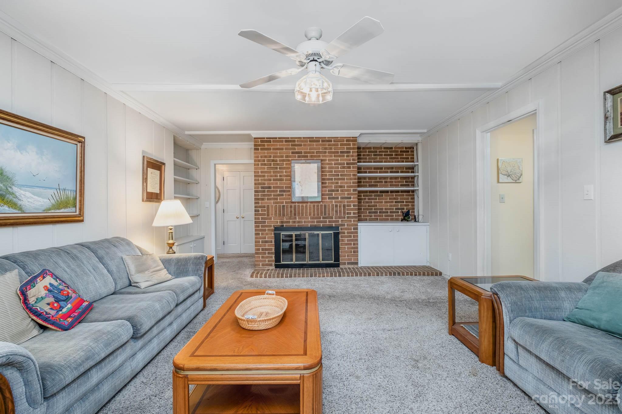5901 Gate Post Road Charlotte, NC 28211 - Photo 11 of 41 a living room with furniture a fireplace and a table