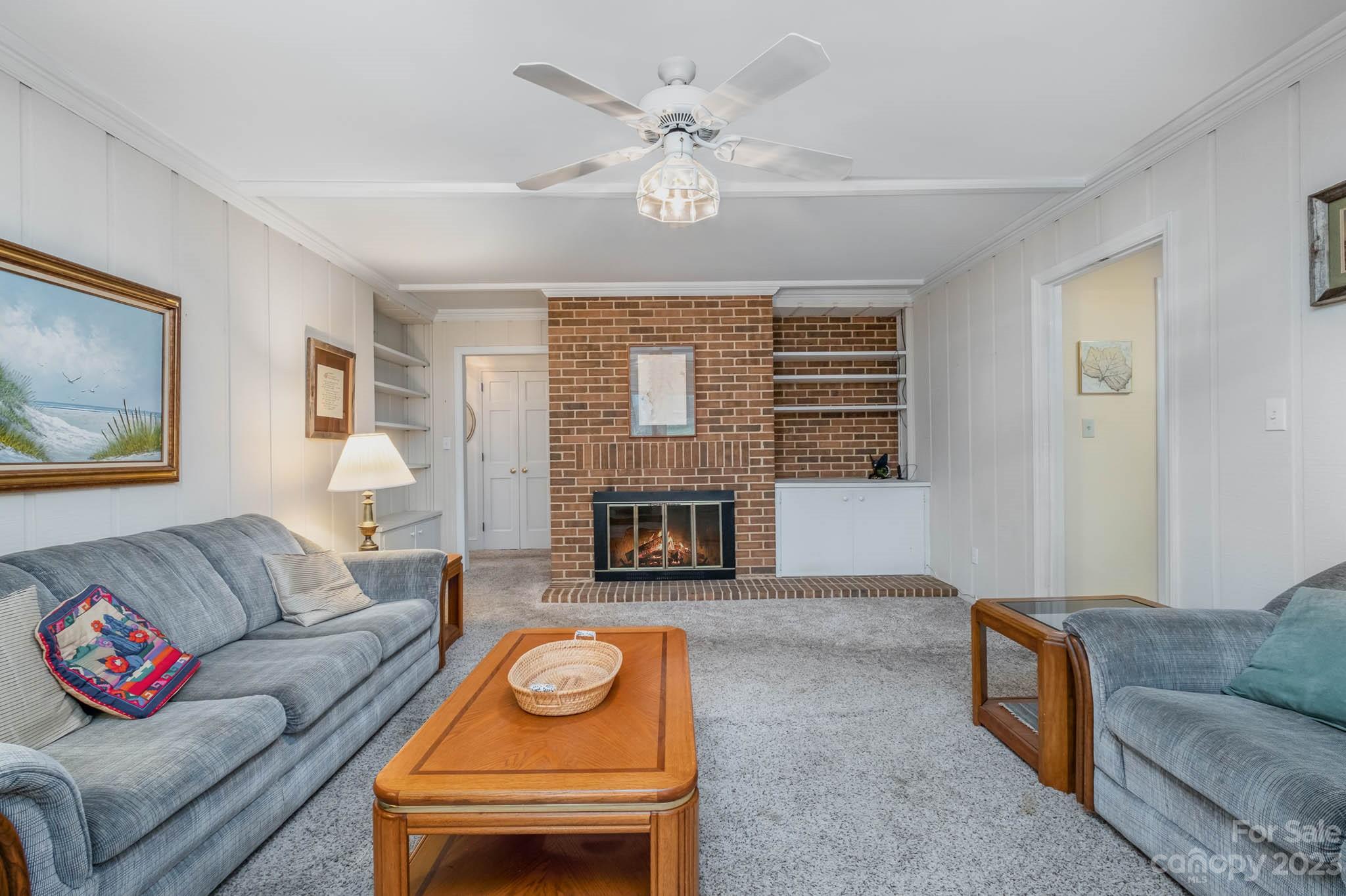 5901 Gate Post Road Charlotte, NC 28211 - Photo 12 of 41 a living room with furniture a fireplace and a table