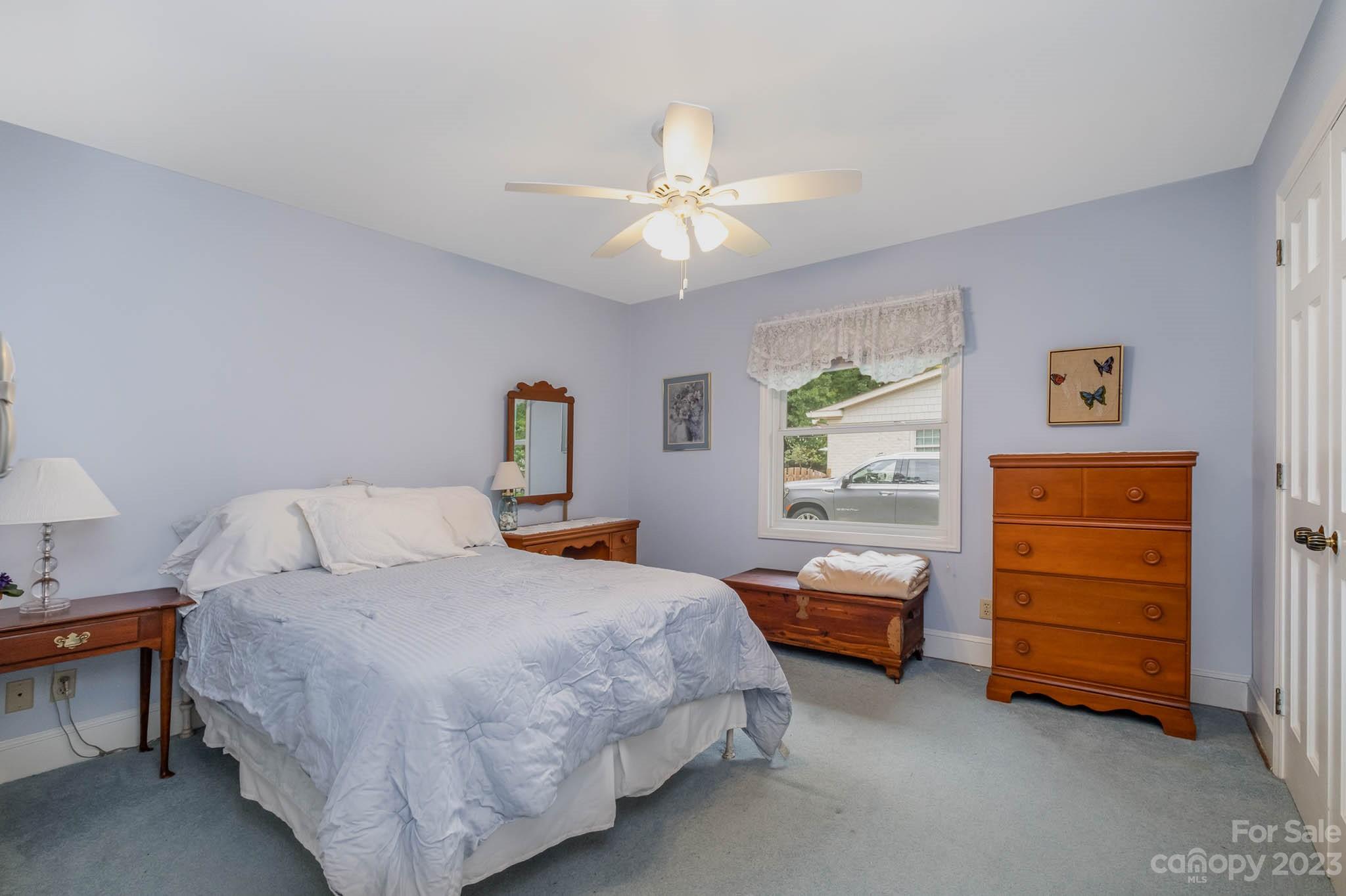 5901 Gate Post Road Charlotte, NC 28211 - Photo 17 of 41 a bedroom with a bed and a chandelier