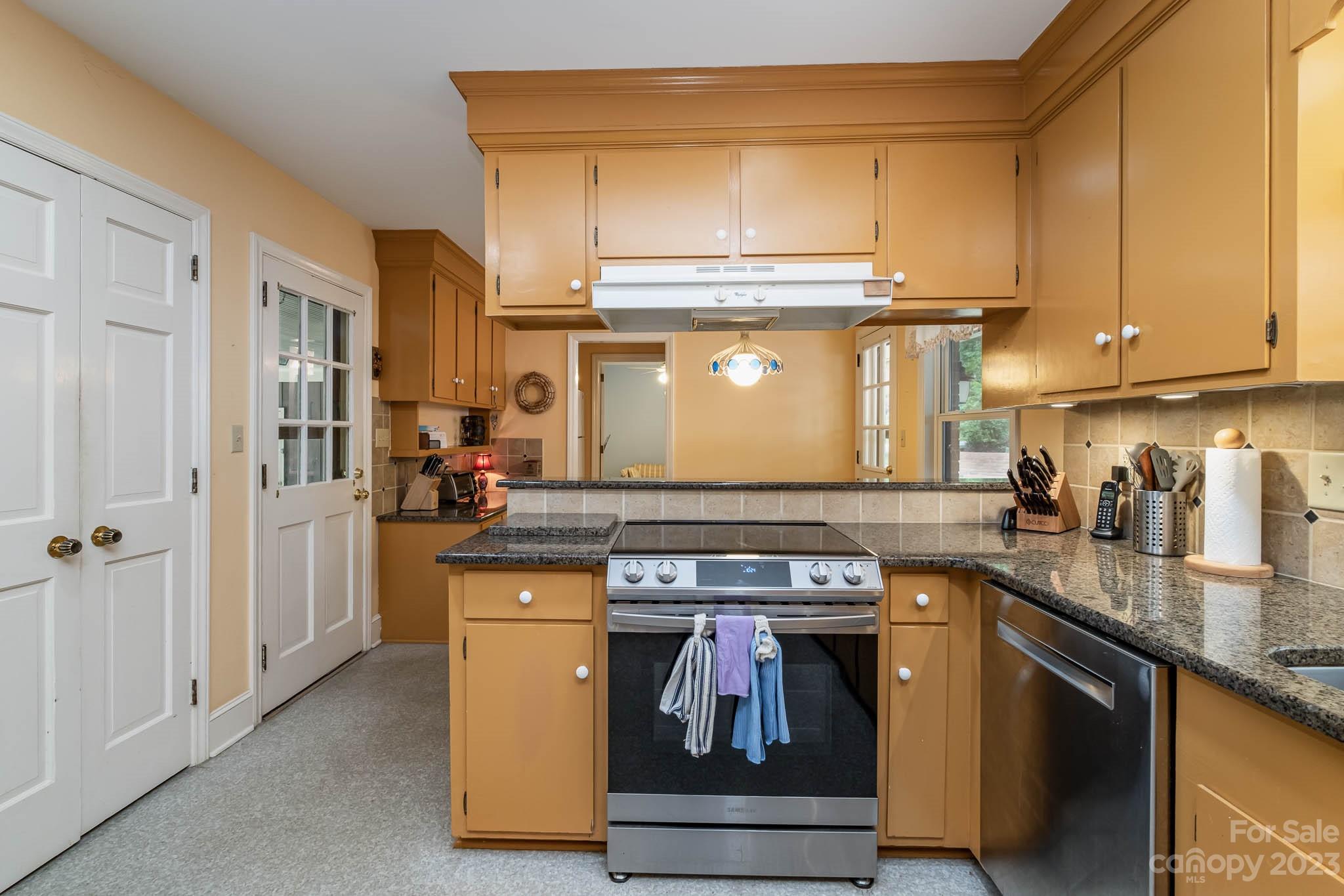 5901 Gate Post Road Charlotte, NC 28211 - Photo 22 of 41 a kitchen with stainless steel appliances granite countertop a stove and a refrigerator