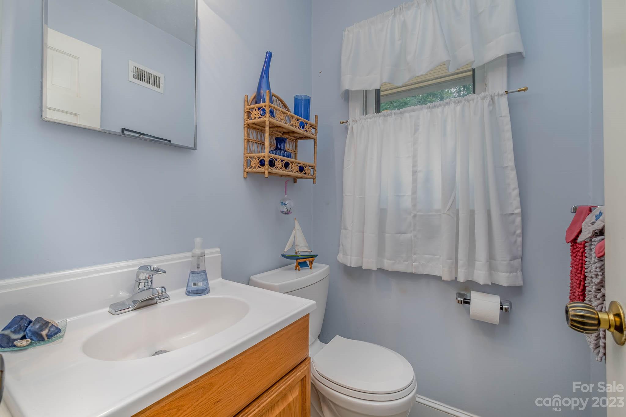 5901 Gate Post Road Charlotte, NC 28211 - Photo 25 of 41 a bathroom with a sink mirror vanity and toilet