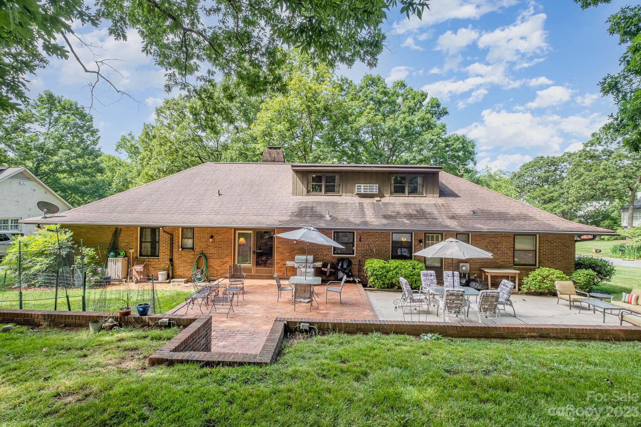 5901 Gate Post Road Charlotte, NC 28211 - Photo 35 of 41 a front view of a house with garden and sitting area