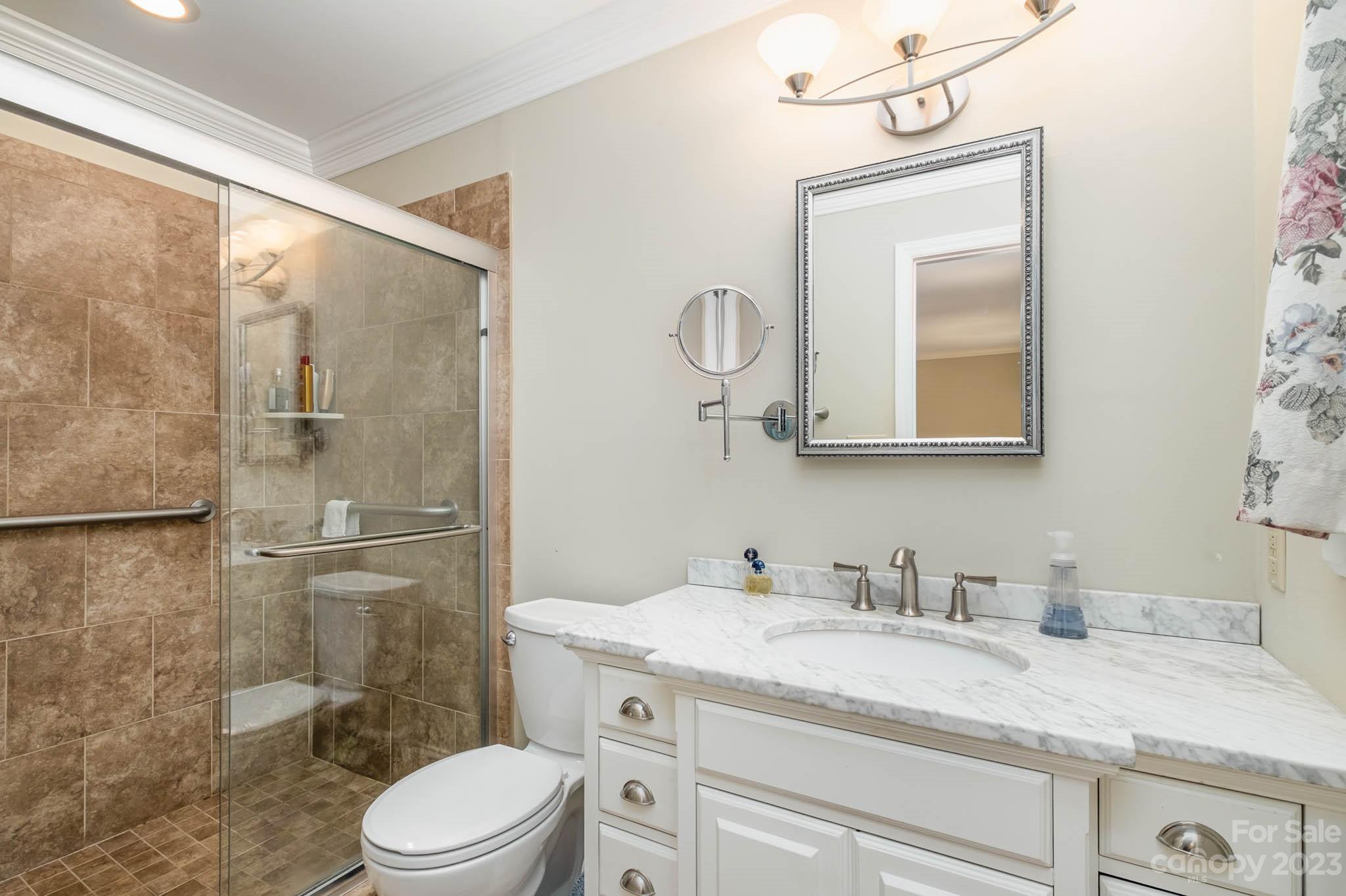 5901 Gate Post Road Charlotte, NC 28211 - Photo 4 of 41 a bathroom with a granite countertop sink a toilet and a mirror