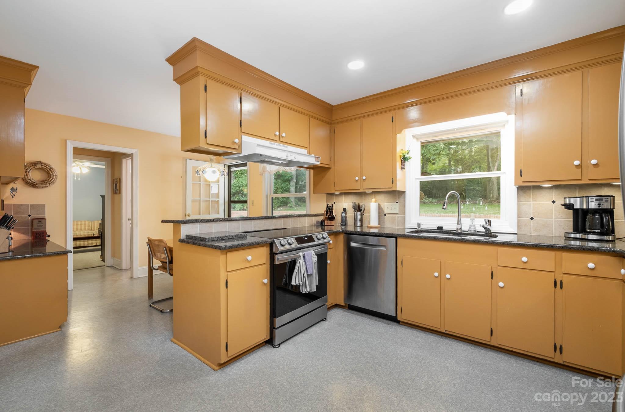 5901 Gate Post Road Charlotte, NC 28211 - Photo 7 of 41 a kitchen with stainless steel appliances granite countertop a stove and a sink