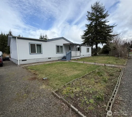 a view of a yard in front of a house with large trees