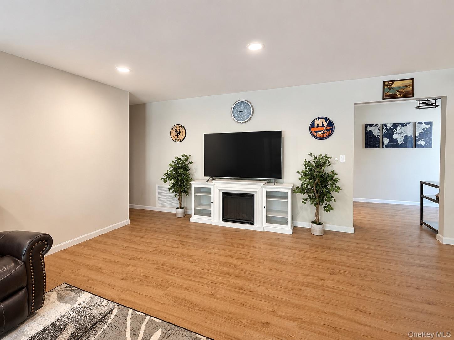 201 Birchwood Road, Unit 201 Coram, NY 11727 - Photo 11 of 27 a living room with furniture and a flat screen tv