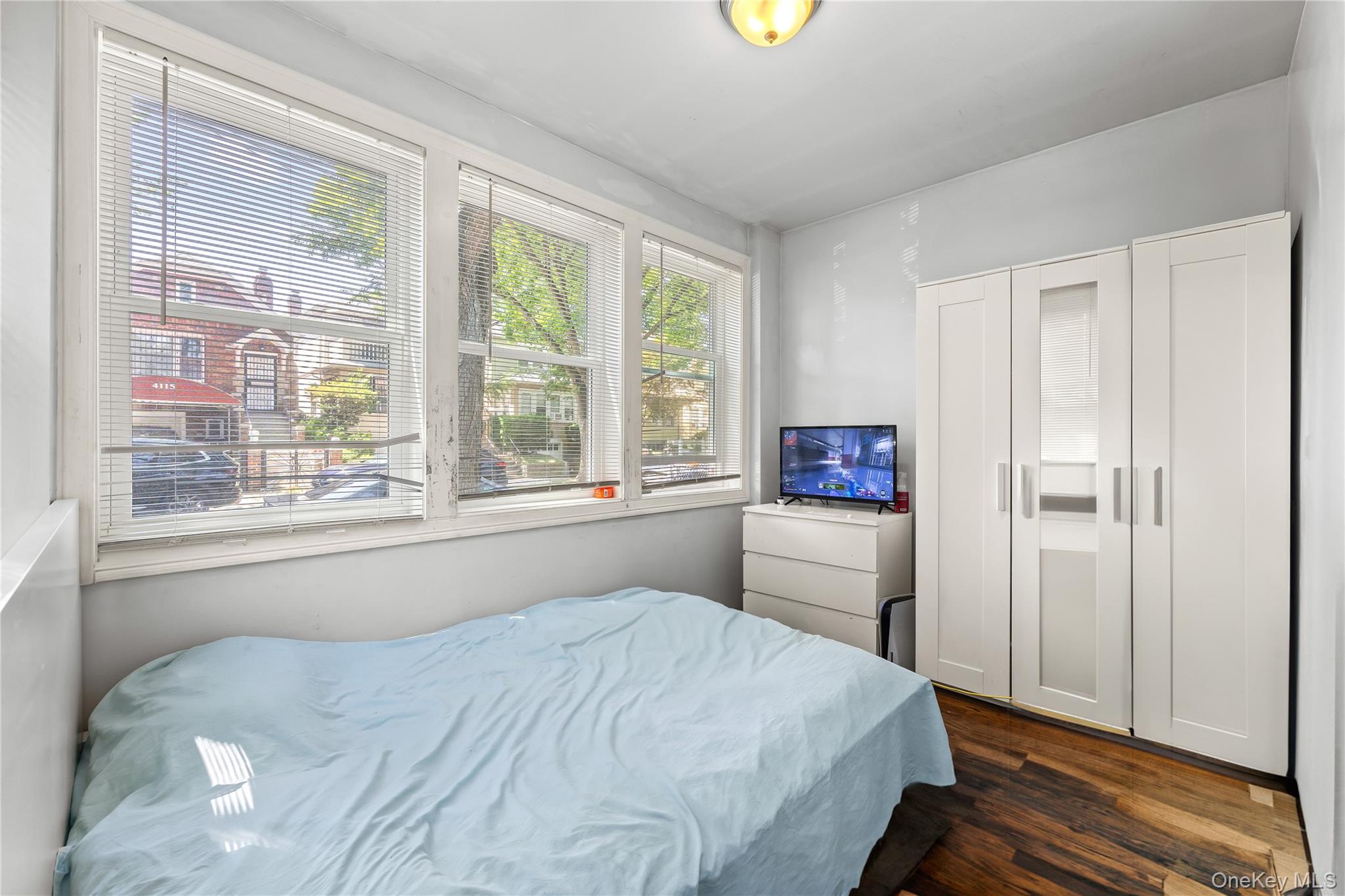 4114 Wickham Avenue Bronx, NY 10466 - Photo 12 of 27 a bedroom with a bed and a large window with outer view