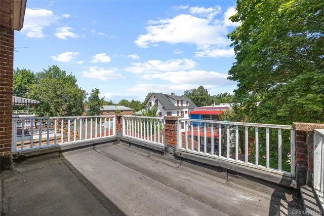 a view of a roof deck with wooden fence