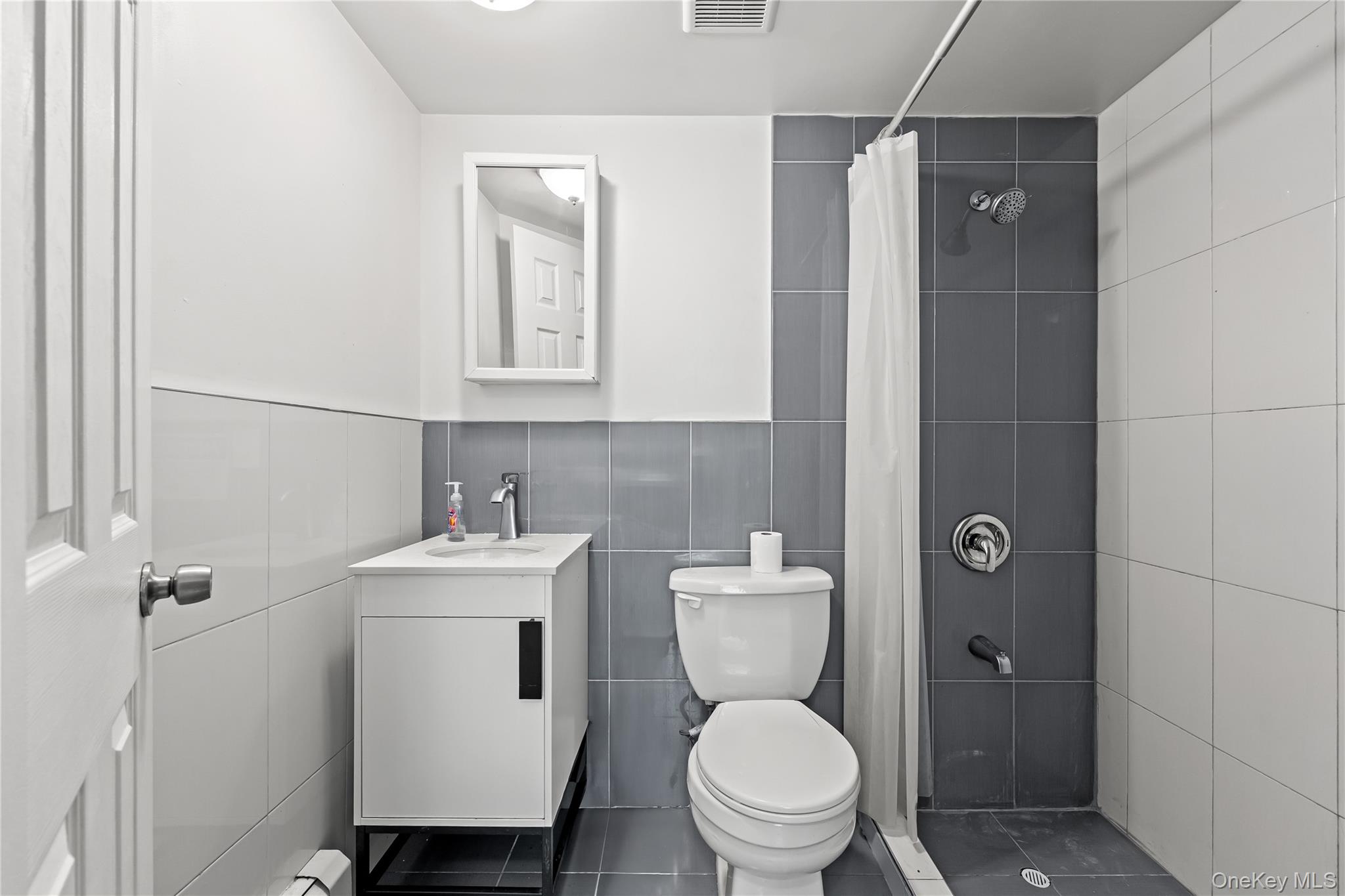 4114 Wickham Avenue Bronx, NY 10466 - Photo 19 of 27 a bathroom with a toilet sink shower and mirror