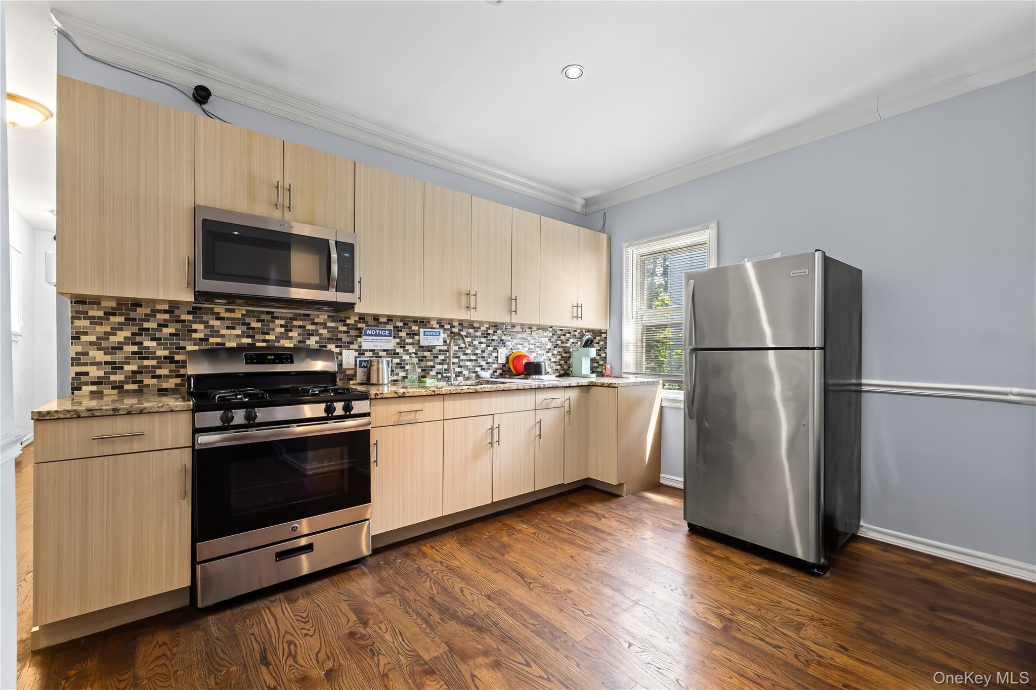 4114 Wickham Avenue Bronx, NY 10466 - Photo 2 of 27 a kitchen with wooden floors and stainless steel appliances