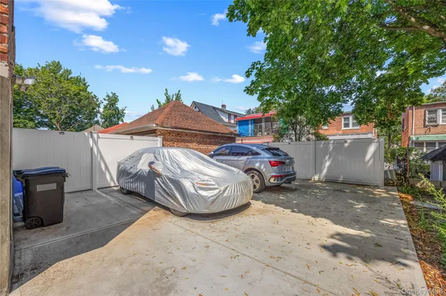 a view of a car park in front of a house