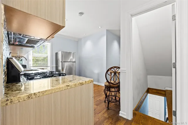 a kitchen with sink refrigerator and stove