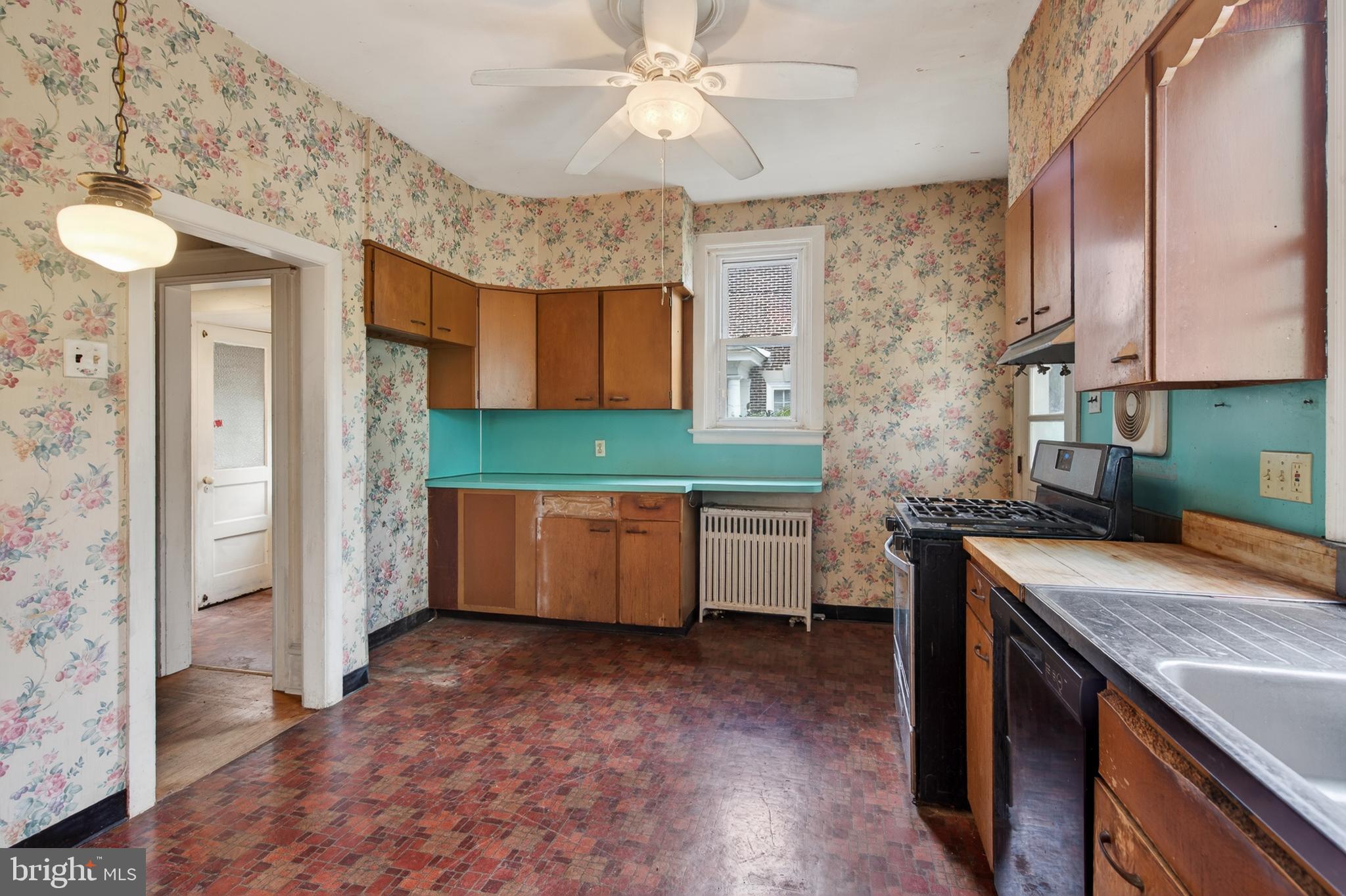 705 East 20th Street Chester, PA 19013 - Photo 11 of 41 a kitchen with a sink and a refrigerator