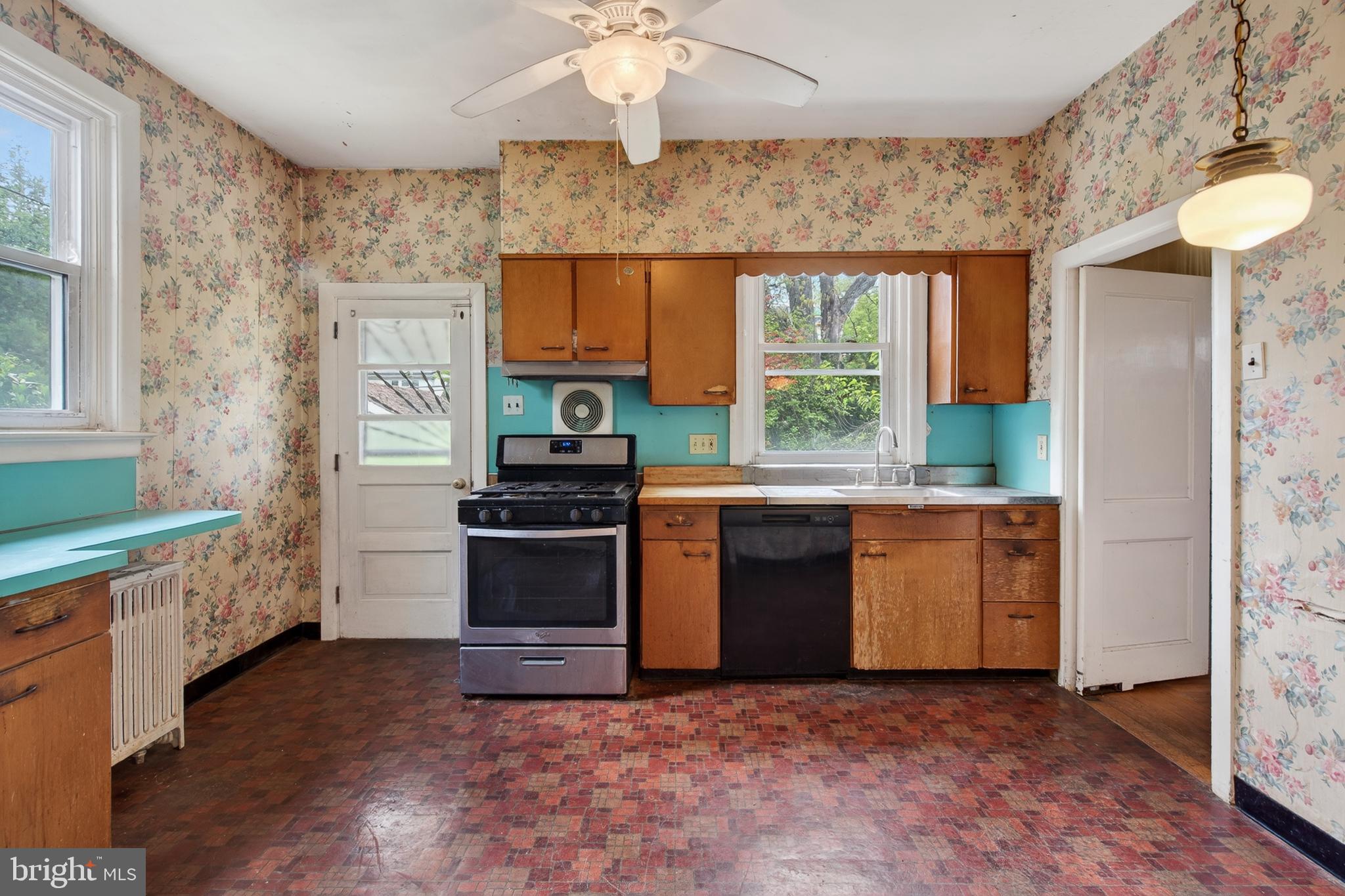 705 East 20th Street Chester, PA 19013 - Photo 12 of 41 a kitchen with stainless steel appliances granite countertop a stove a sink and a refrigerator