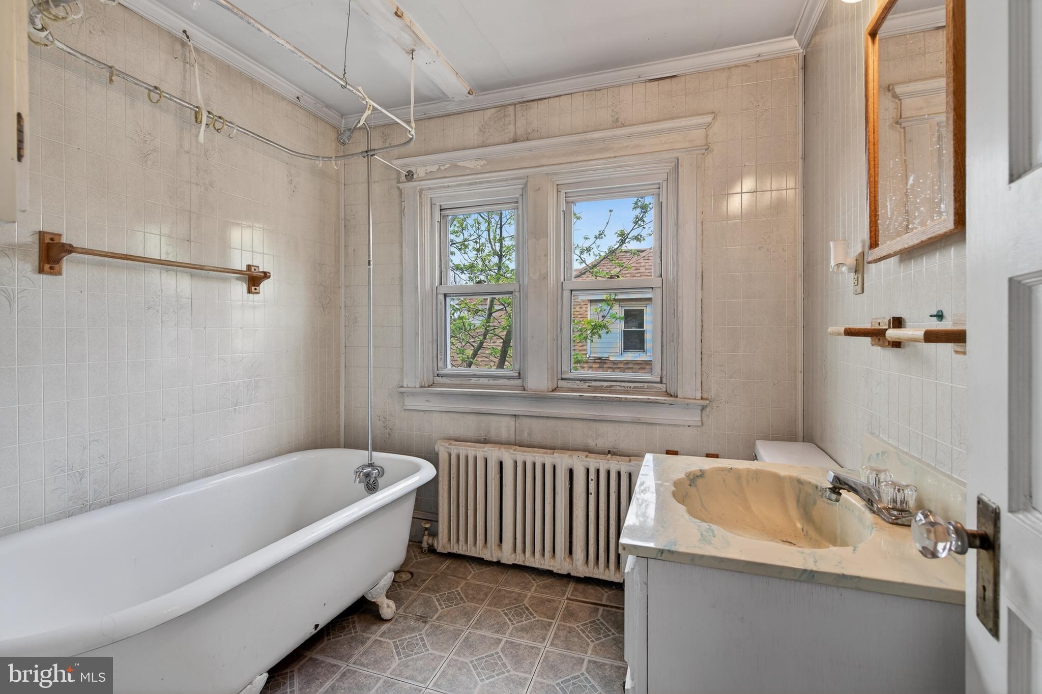 705 East 20th Street Chester, PA 19013 - Photo 17 of 41 a bathroom with a tub sink and window