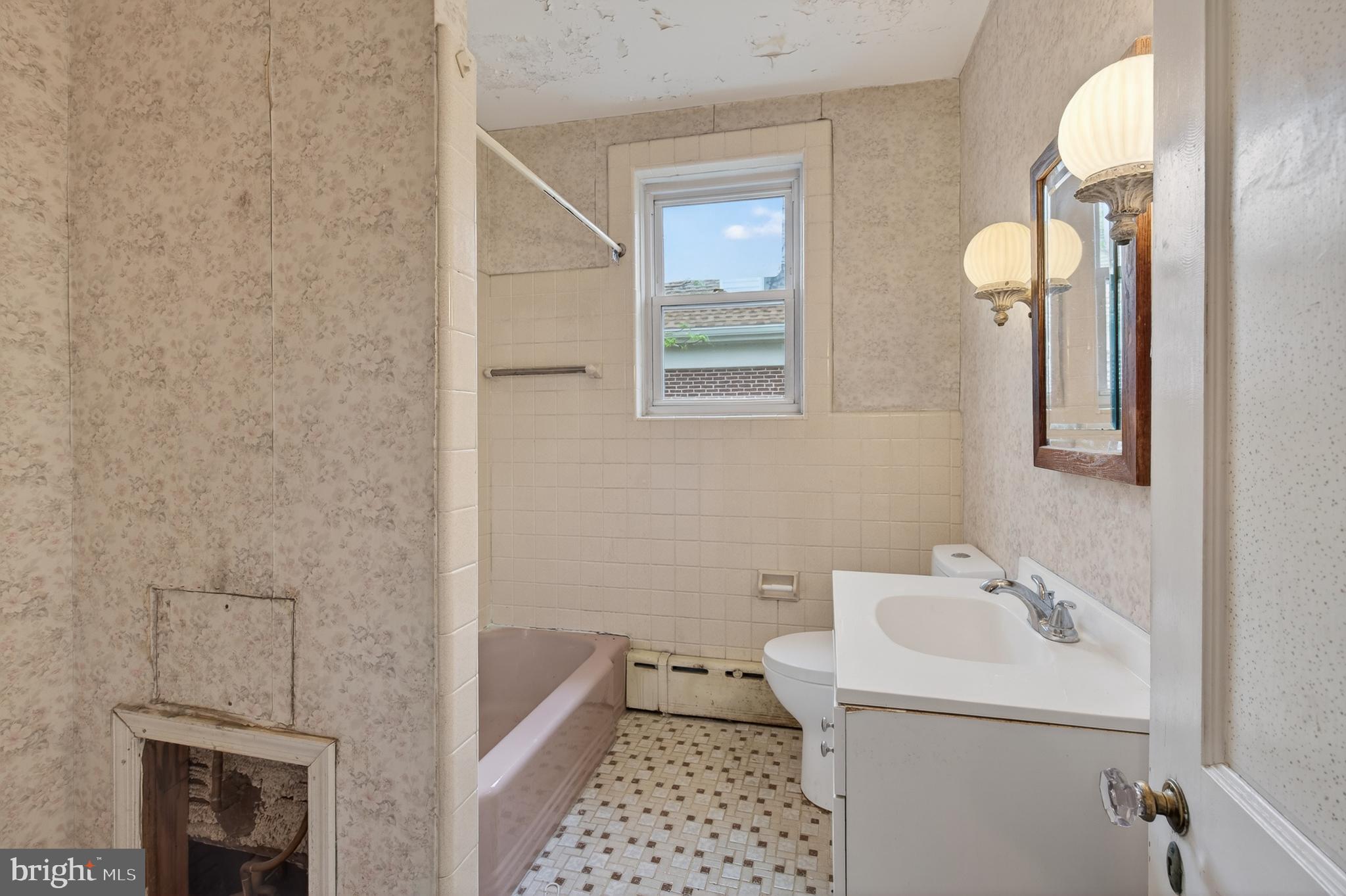 705 East 20th Street Chester, PA 19013 - Photo 23 of 41 a bathroom with a sink a toilet and shower