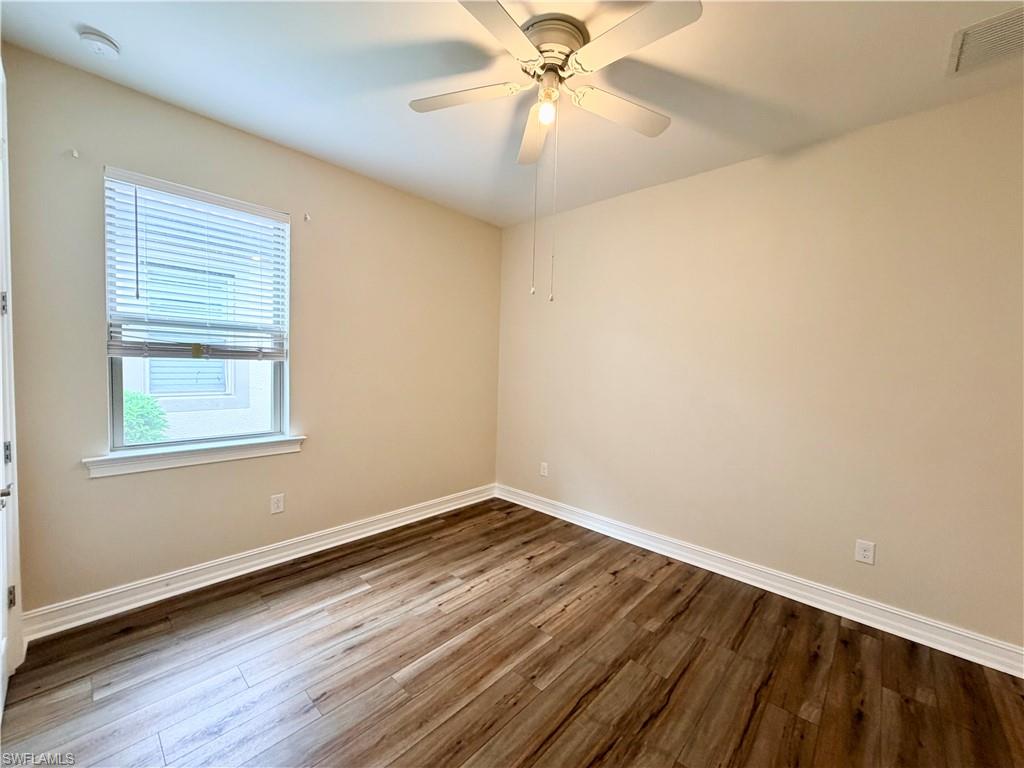 16432 Aberdeen Way Naples, FL 34110 - Photo 11 of 21 a view of an empty room with wooden floor and a window