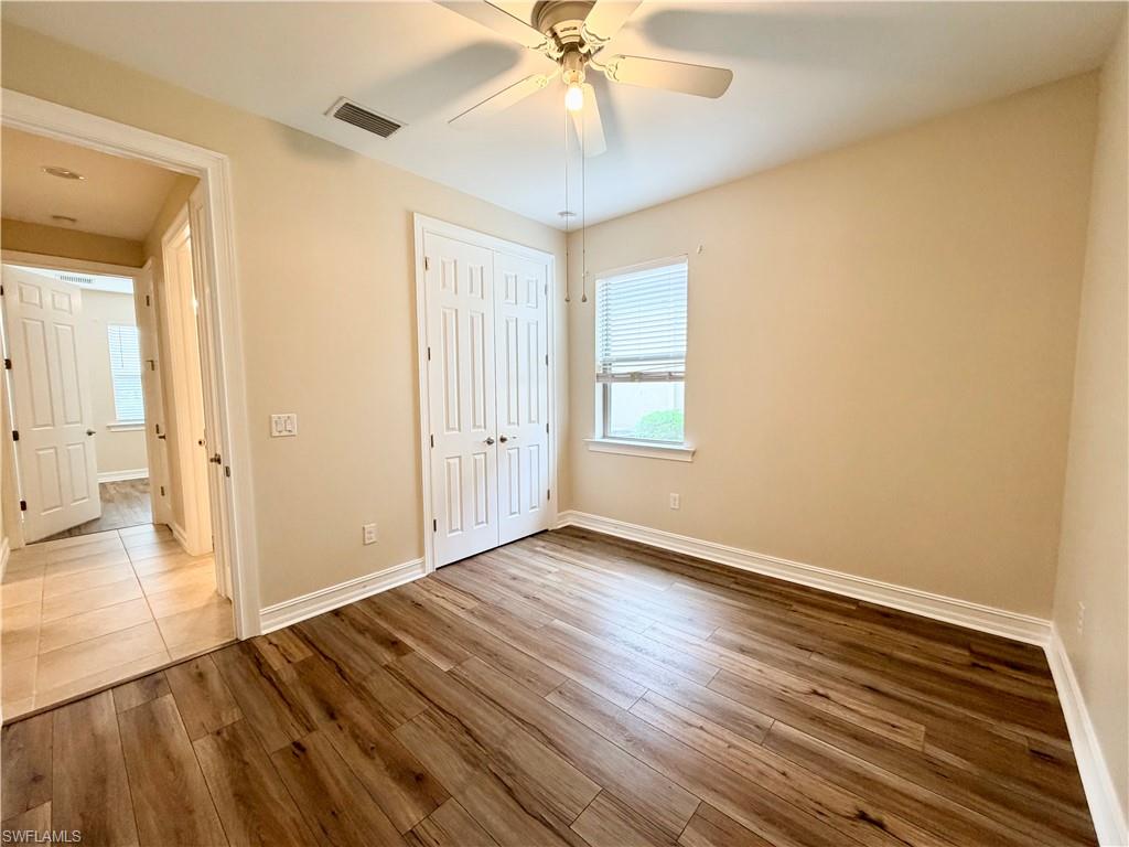 16432 Aberdeen Way Naples, FL 34110 - Photo 12 of 21 a view of an empty room with wooden floor and a window