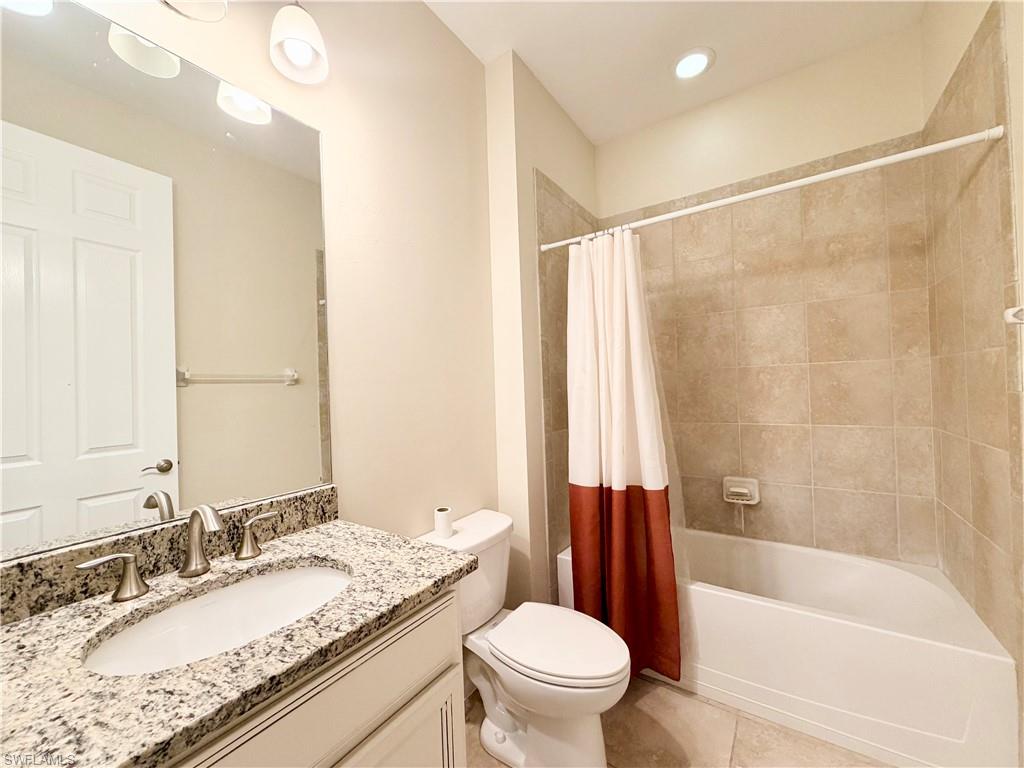 16432 Aberdeen Way Naples, FL 34110 - Photo 13 of 21 a bathroom with a granite countertop tub sink toilet mirror and a shower