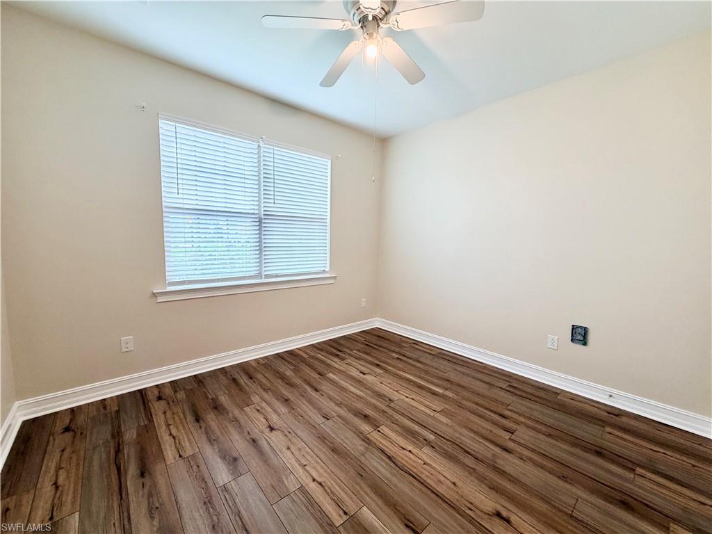 16432 Aberdeen Way Naples, FL 34110 - Photo 14 of 21 wooden floor in an empty room with a window
